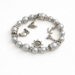Nautical-themed stretch bead and Silver charm bracelet.